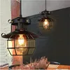 Two vintage-style pendant lights hang over a table with dried flowers. Produktbild-Vorschau