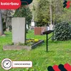 A cemetery scene with a gravestone and a small black bench. Voir les images du produit