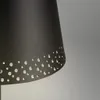 A close-up view of the bottom part of a black lampshade with a pattern of small holes. Produktbild-Vorschau