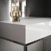 A close-up shot of a white vanity table with a gold vase and dried flowers. Produktbild-Vorschau