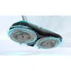A close-up, dynamic shot of a robotic vacuum cleaner's cleaning head with spinning brushes, illustrating its cleaning action with particles being swept up. Náhled obrázku produktu