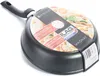 A black frying pan with a label showing food and product information. Podgląd zdjęcia produktu