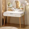 A white vanity table with a round mirror and wooden legs, adorned with makeup and skincare products. Fairy lights add a decorative touch. Anteprima dell’immagine prodotto