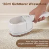 A hand holding a white garment steamer over a textured surface. Produktbild-Vorschau
