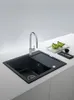 A modern kitchen sink with a faucet and a cutting board. Anteprima dell’immagine prodotto