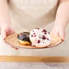 Hands holding a plate with two donuts. Náhled obrázku produktu