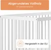 Close-up of a white baby crib with text overlays. Produktbild-Vorschau