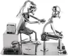 A metal sculpture of a tattoo artist tattooing a client. Podgląd zdjęcia produktu