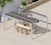 An outdoor dining set under a pergola on a wooden deck. Podgląd zdjęcia produktu