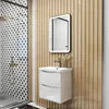 A modern bathroom vanity with a sink, faucet, and mirror, set against a wood-paneled wall and a patterned tiled shower area. Produktbild-Vorschau
