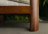 A close-up view of the wooden leg and underside of a side table, with newspapers visible underneath. Anteprima dell’immagine prodotto