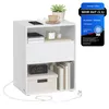 A white nightstand with various items on and inside it, including a phone, a plant, books, and a clock. A promotional badge is visible on the right side. Produktbild-Vorschau