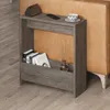 A modern side table next to a couch, with books and decor on it. Produktbild-Vorschau