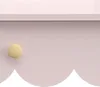 A close-up of a pink dresser or vanity with a wooden knob. Produktbild-Vorschau