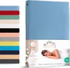 A fitted sheet is shown folded on the right side of the image, with a collage of product features and a woman sleeping on a bed on the left. Produktbild-Vorschau