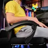 A person sitting in a gaming chair, with a computer monitor and colorful lights in the background. Produktbild-Vorschau