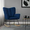 A dark blue rocking chair with wooden legs sits on a patterned rug next to a small side table with a teapot and cup. Náhled obrázku produktu