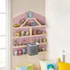 A wall shelf filled with children's toys and a small gray audio device. Produktbild-Vorschau