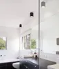 A modern bathroom with a bathtub, toilet, vanity, and large mirror. Produktbild-Vorschau
