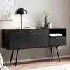 A black sideboard with gold accents in a living room setting. Podgląd zdjęcia produktu