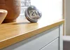 A close-up view of a wooden sideboard surface with decorative items on it. Podgląd zdjęcia produktu