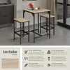 A bar set with two stools and a table, presented in a modern interior setting with accompanying product feature descriptions. Produktbild-Vorschau