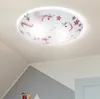 A close-up view of a ceiling light fixture with a unicorn and star pattern, mounted on a white ceiling. Produktbild-Vorschau