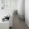 A modern bathroom with a sink, toiletries, and laundry baskets. Náhľad obrázku produktu