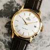 A close-up shot of a gold-toned watch with a white face and a brown leather strap, set against a marbled background. Produktbild-Vorschau