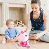 A mother and baby are playing with a plush unicorn toy in a living room. Anteprima dell’immagine prodotto