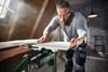 A man is using a jigsaw in a workshop setting. Produktbild-Vorschau