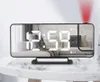 A digital alarm clock with a projector is displayed on a marble table. Náhled obrázku produktu
