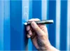 A hand is using a marker to write on a blue corrugated surface. Anteprima dell’immagine prodotto