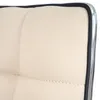 Close-up of the edge of a cream-colored chair cushion with black trim and a chrome edge. Náhled obrázku produktu