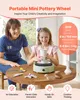 A mother and daughter are using a mini pottery wheel on a wooden table. Podgląd zdjęcia produktu