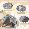 A children's play tent with decorative elements like lights and flags, shown indoors. Voir les images du produit