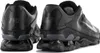Two black Nike Reax 8 Tr Mesh sneakers are shown from a rear-side angle against a white background. Produktbild-Vorschau