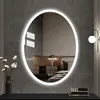 A modern bedroom setting with a large oval LED mirror. Náhled obrázku produktu