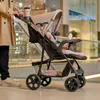 A person pushing a baby stroller in a shopping mall. Voir les images du produit