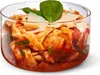 A close-up of pasta in a glass bowl, garnished with basil and parmesan cheese. Anteprima dell’immagine prodotto