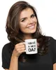 A woman is holding a white mug with black text that says "HAVE A NICE DAY". Náhled obrázku produktu