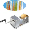 A stainless steel spiral potato slicer with a potato attached to it, and a display of colorful spiral-cut vegetables in the background. Náhľad obrázku produktu