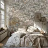 A bedroom scene with a bed and stone-patterned wallpaper. Produktbild-Vorschau