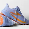 A pair of purple and orange Brooks running shoes on a white background. Produktbild-Vorschau