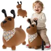 A child is playing with a bouncy dog toy, with other bouncy dog toys shown in the background. Produktbild-Vorschau