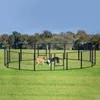 Two dogs playing inside a black metal dog enclosure in a grassy field with trees in the background. Náhled obrázku produktu