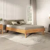 A bedroom scene with a wooden bed frame and bedding. Produktbild-Vorschau