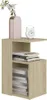 A light brown wooden side table with shelves, holding books, a vase with flowers, and a clock. Náhled obrázku produktu