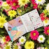 A TOPModel hand designer coloring book is placed on a bed of colorful flowers. Anteprima dell’immagine prodotto