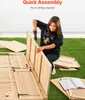A young woman is assembling a wooden shed on a grassy lawn. Produktbild-Vorschau